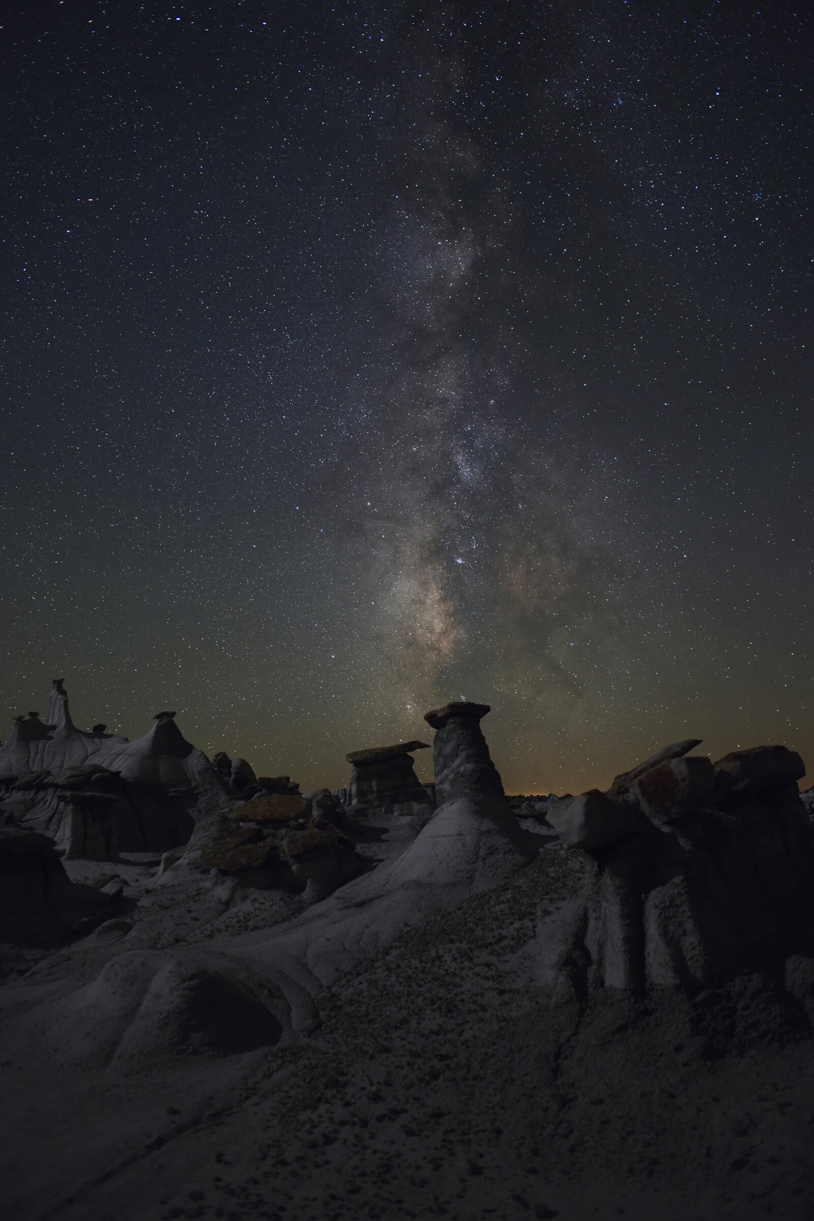 Starry night sky over desert landscape